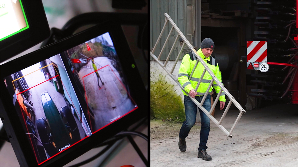 Vergrößerung des Bildes für Auf einem Kamera-Display ist ein Mann mit einer Leiter zu sehen, der hinter einem Fahrzeug läuft..